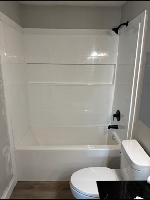 Finished bathroom with new tub, tile surround, fixtures and flooring, Regina SK