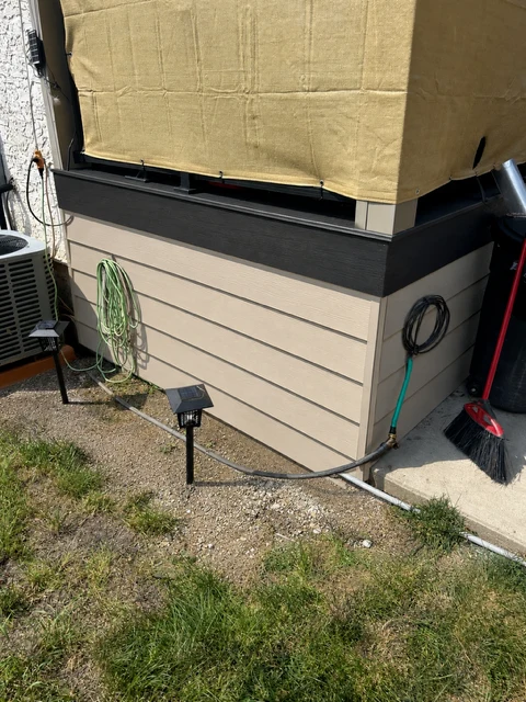 New composite deck skirting with black trim cap replacing rotted wood, Regina SK